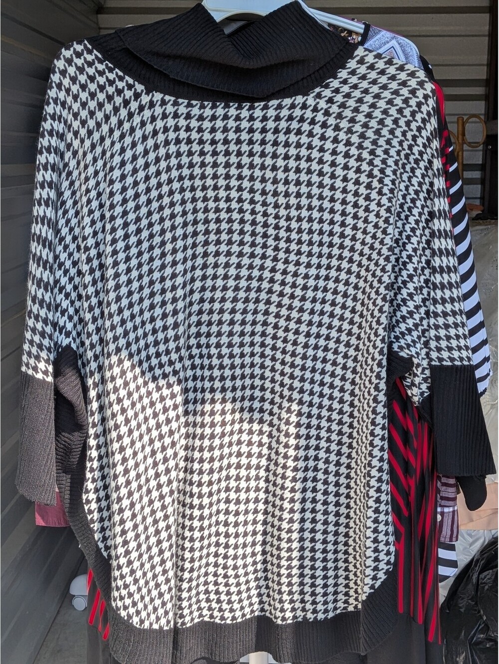 Black and white houndstooth cowl neck sweater